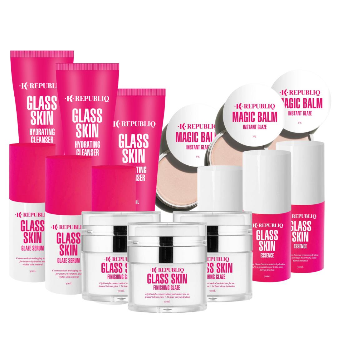 A collection of K Republiq skincare products, including the Glass Skin Hydrating Cleanser, Magic Balm, Glazing Essence, Glaze Serum, and Finishing Glaze, displayed in repackaged pink and white bottles and tubes.