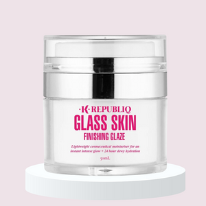 A clear jar of K·Republiq Glass Skin Finishing Glaze, a lightweight moisturizer, sits on a white circular stand against a pink background.