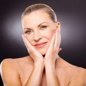 Mature woman with radiant and smooth skin smiling after using K Republiq skincare