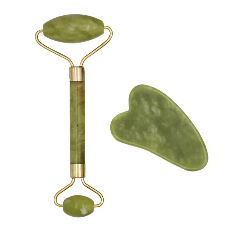 A set of jade facial tools including a roller and a gua sha board, both in green color.