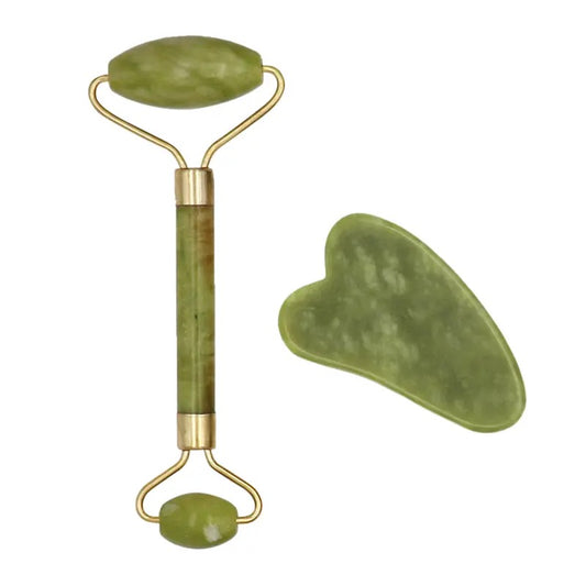 A set of jade facial tools including a roller and a gua sha board, both in green color.