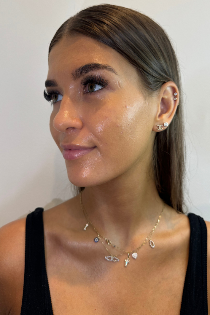 A close-up, side profile shot of a young woman with healthy and dewy skin