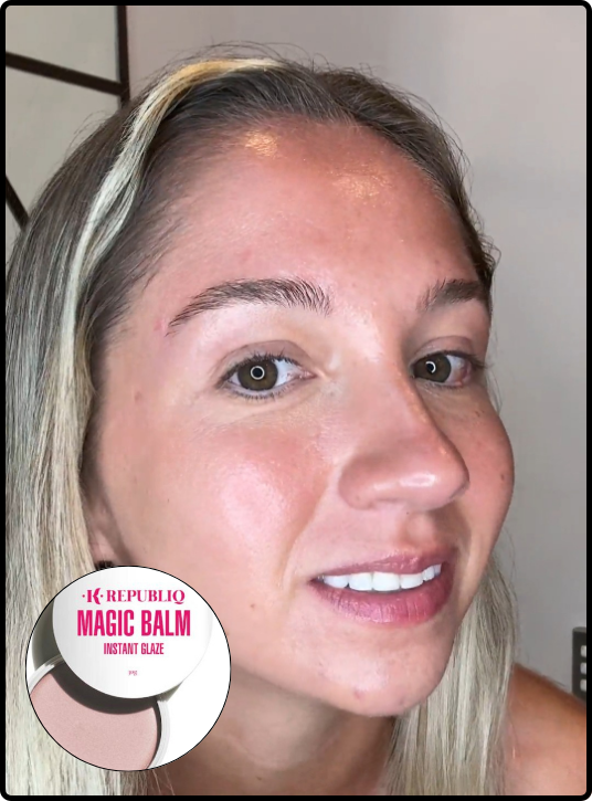 A close-up shot of a smiling woman with light-colored hair, showing a dewy, glowing skin finish. In the bottom left corner, there is a circular inset image of a K Republiq Magic Balm product container.